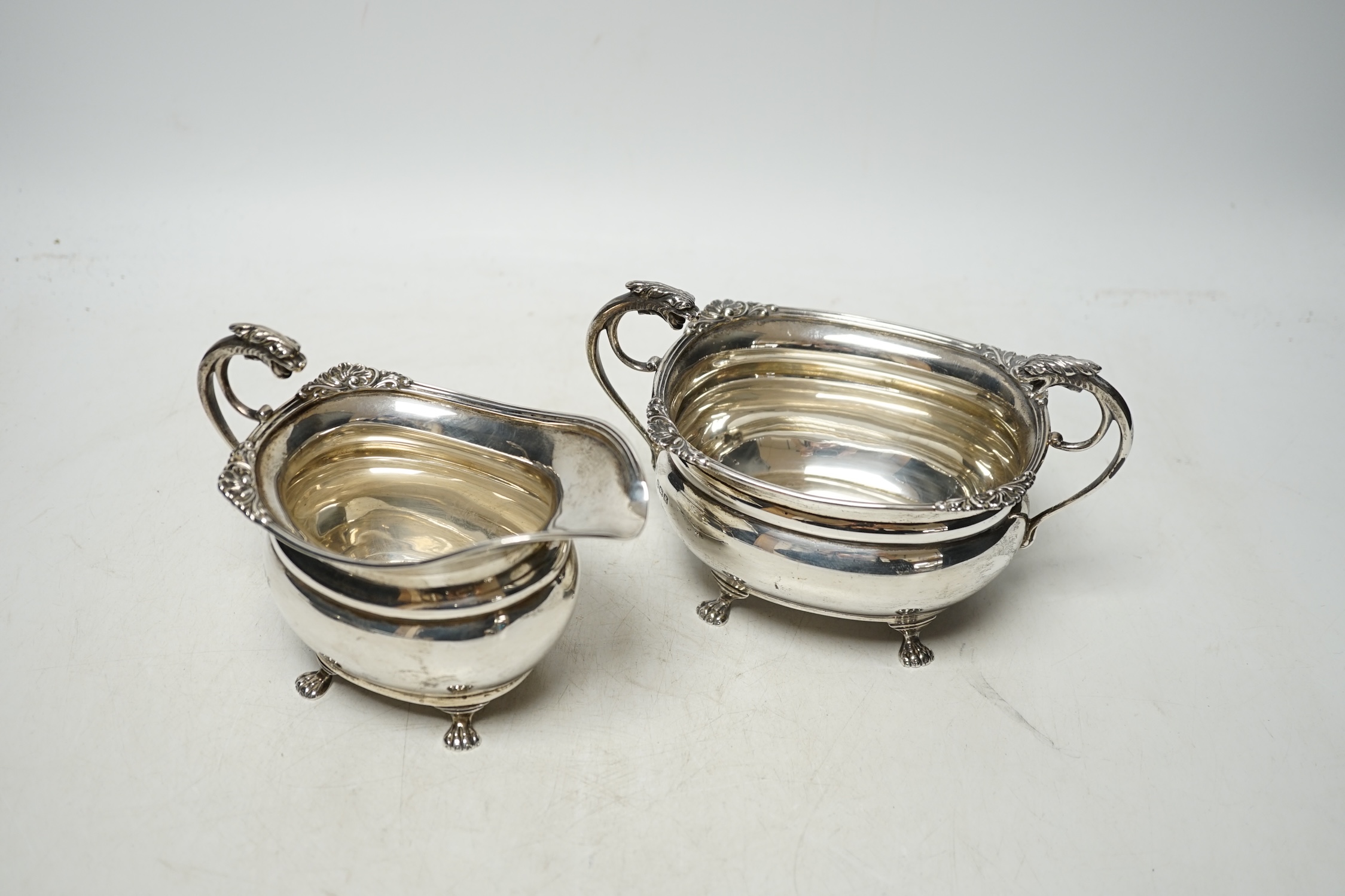 A George V silver cream jug and sugar bowl, by Alexander Clark Co. Ltd, Birmingham, 1922, 13.8oz. Condition - fair to good